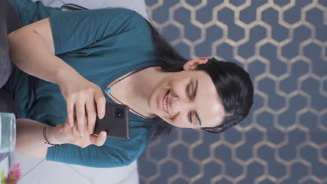 Vertical-video-of-Woman-texting-with-happy-expression.